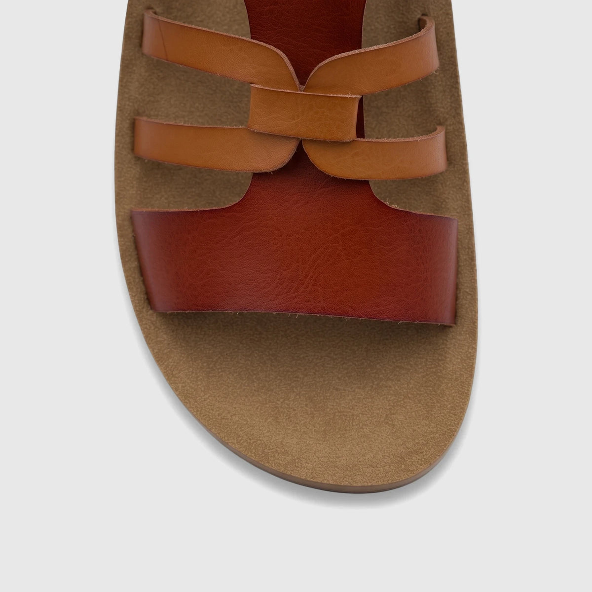 Close-up of PC Ladies Casual Sandal PCL11018 featuring tan and reddish-brown criss-cross straps and a textured tan sole.