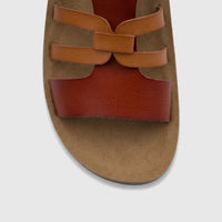 Close-up of PC Ladies Casual Sandal PCL11018 featuring tan and reddish-brown criss-cross straps and a textured tan sole.