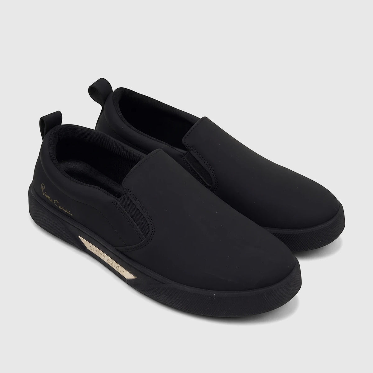 A pair of black PC Ladies Casual Slip On Sneakers PCL11019, featuring gold Pierre Cardin branding and elastic goring, viewed
