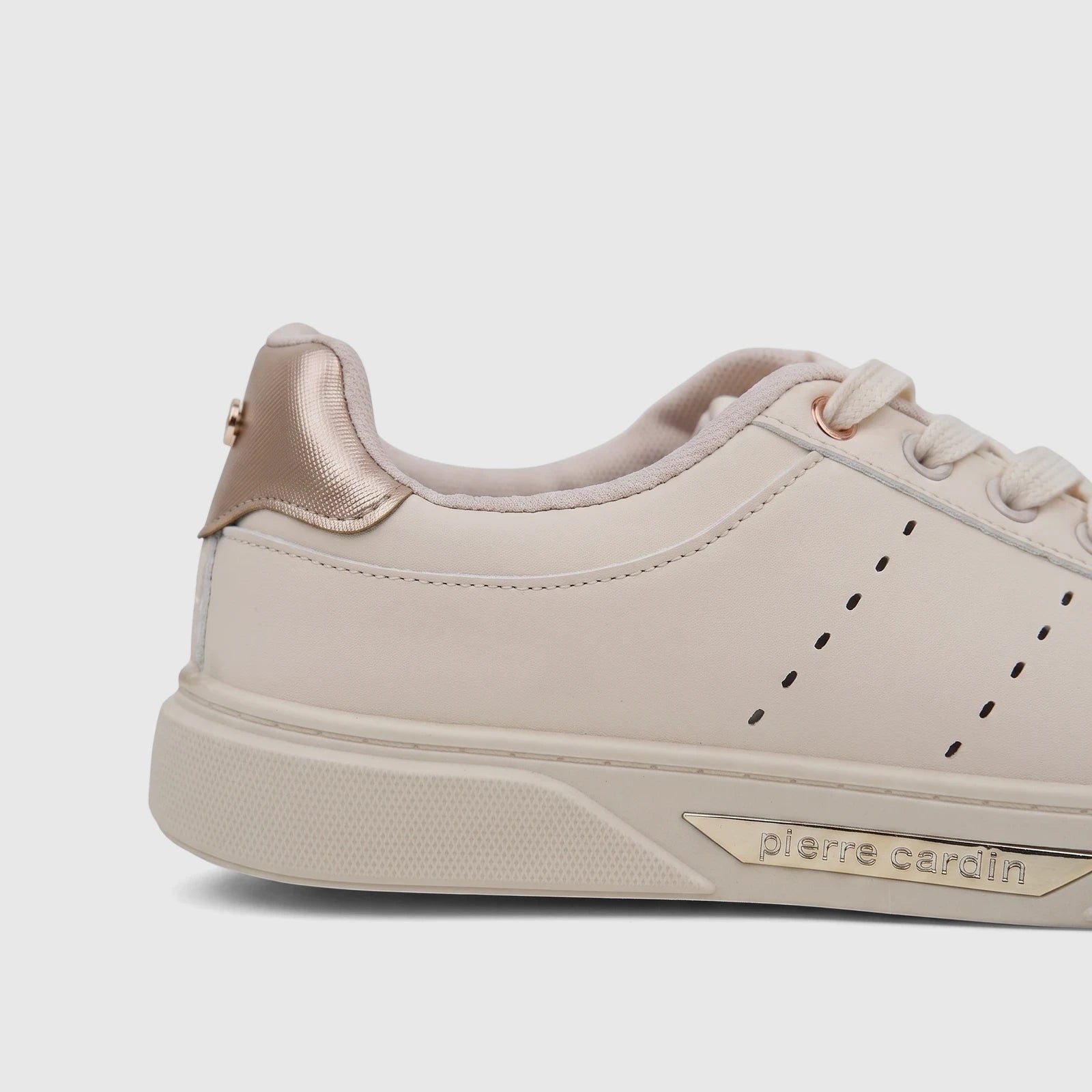 Close-up side view of a PC Ladies Casual Sneaker in beige with gold metallic accents and cream laces.