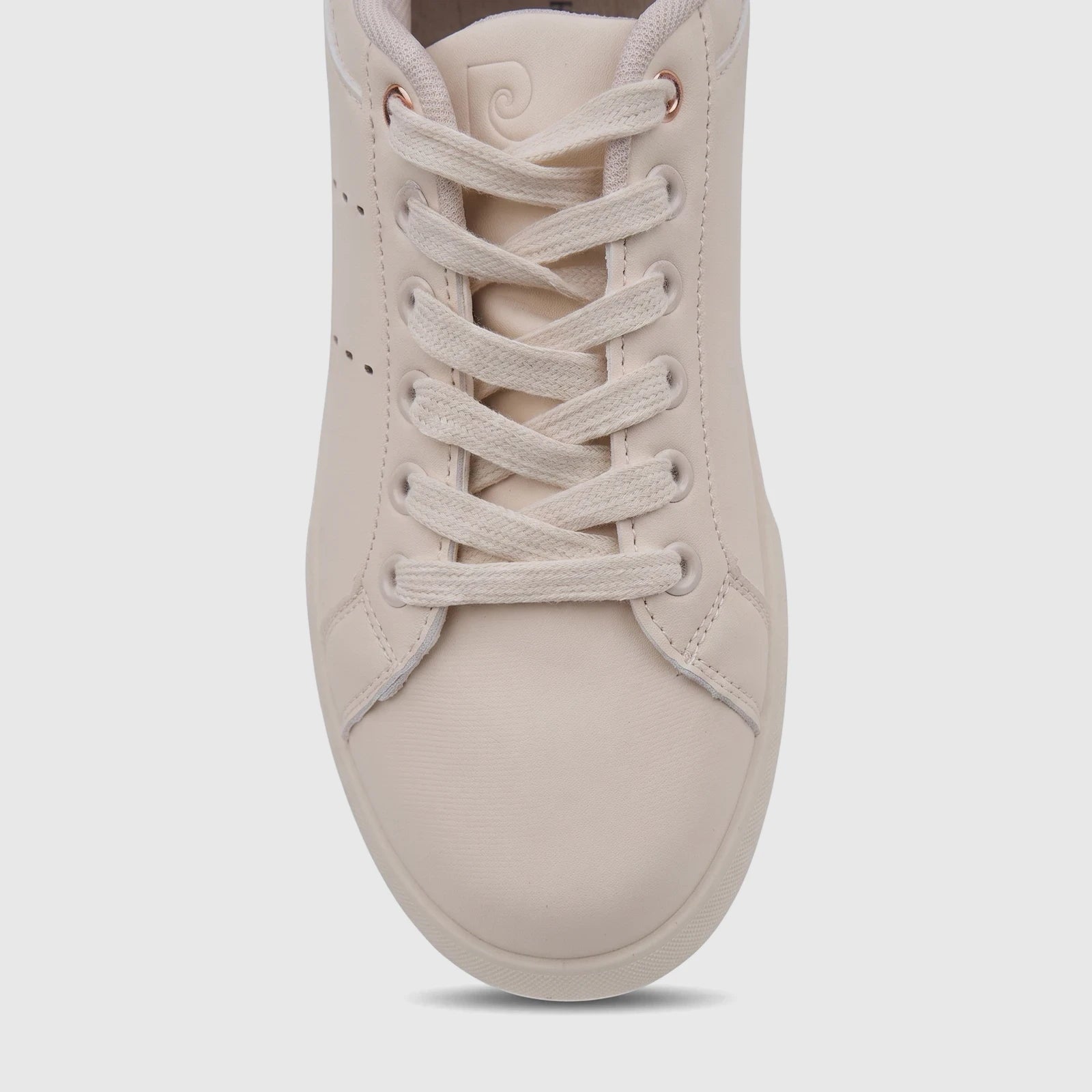 Close-up front view of a beige PC Ladies Casual Sneaker PCL11017. The shoe features white laces, rose gold eyelets, and a
