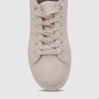 Close-up front view of a beige PC Ladies Casual Sneaker PCL11017. The shoe features white laces, rose gold eyelets, and a