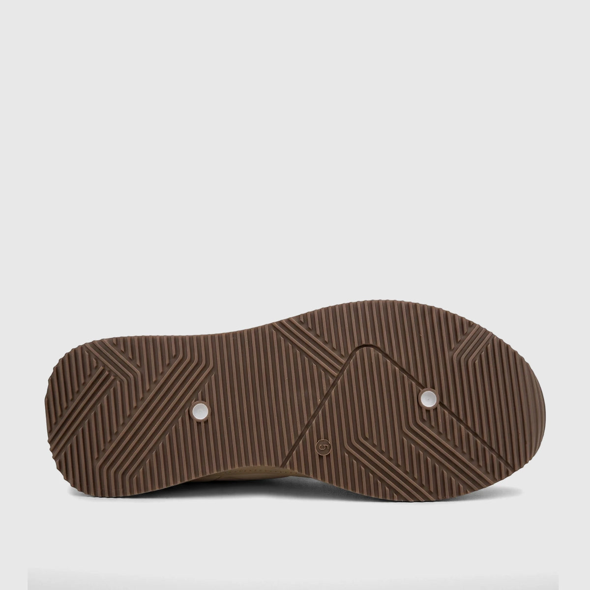 Underside view of a PC Ladies Casual Sneaker in beige tan, featuring a textured brown rubber sole with two white plugs and a