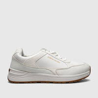 White Pierre Cardin PCL10987 ladies' casual sneaker with textured panels and a brown rubber sole, shown in a side view.