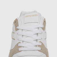 Close-up of a white Pierre Cardin ladies casual sneaker with white laces and beige accents on the tongue, showing the brand