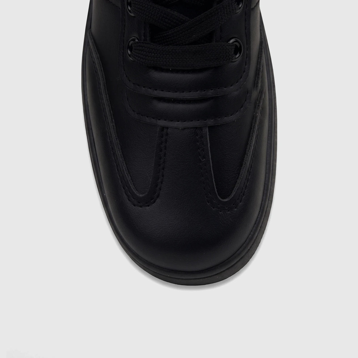 A close-up, top-down view of a PC Ladies Casual Sneaker PCL11006 in black, featuring visible laces and detailed stitching.