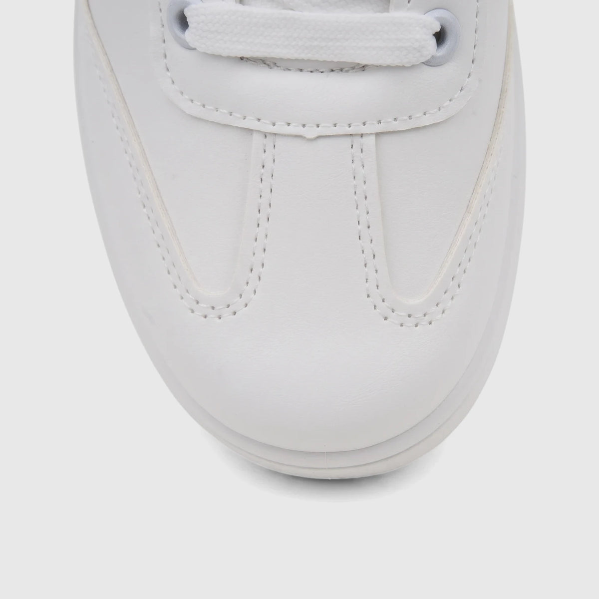 Close-up view of a white PC Ladies Casual Sneaker PCL11006, showcasing the front of the shoe with laces, eyelets, and