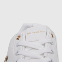Close-up of a white Pierre Cardin PCL11006 casual sneaker with golden eyelets and the brand logo on the tongue.