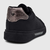 Close-up rear view of a PC Ladies Casual Sneaker in black, featuring a textured metallic silver heel panel and black sole.