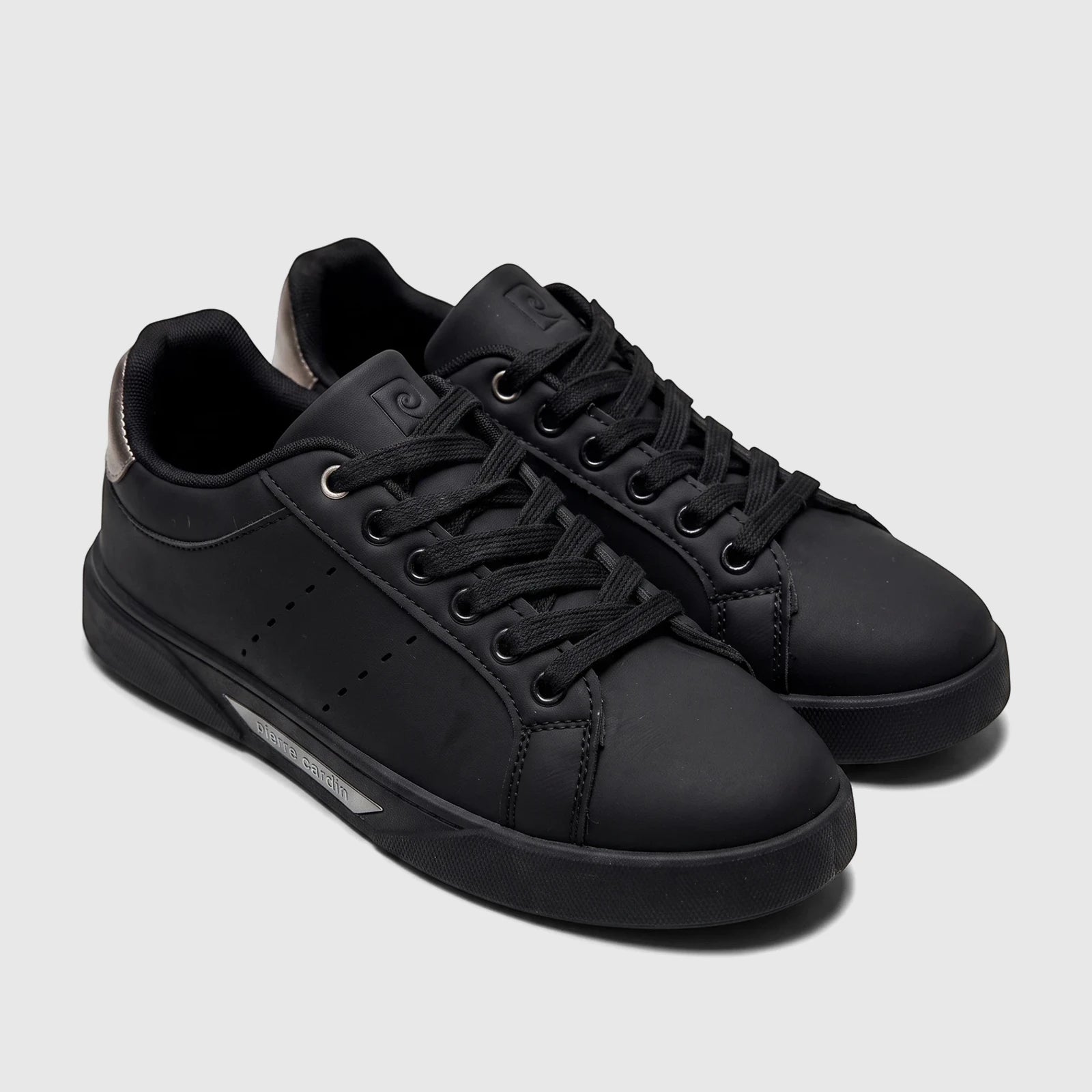 A pair of black PC Ladies Casual Sneakers PCL11017, featuring black laces, silver accents on the heel, and a side sole logo.