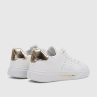 White Pierre Cardin PCL11017 casual sneakers for ladies with gold accents on the heel and sole, viewed from the side.