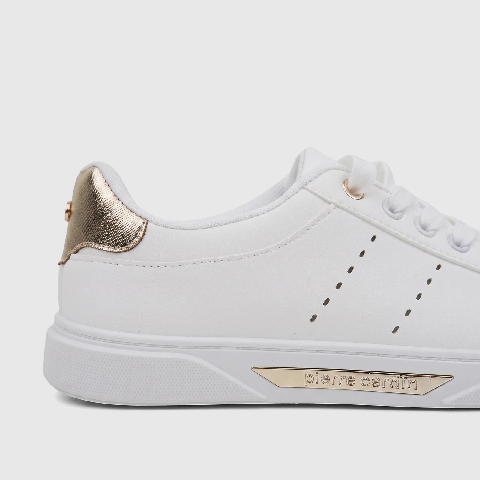White PC Ladies Casual Sneaker with gold heel and branding, visible from a side angle, showcasing its design details and