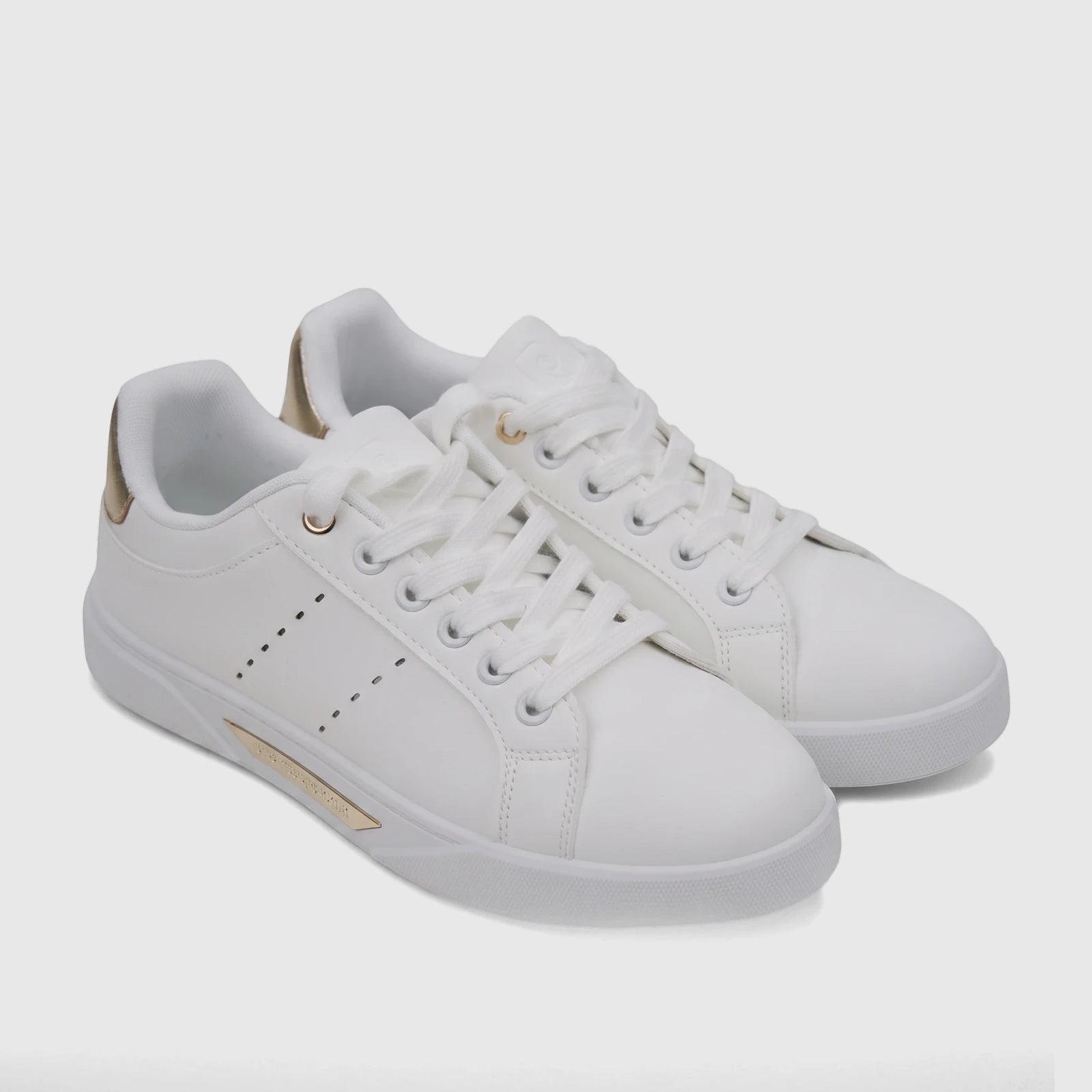 A pair of PC Ladies Casual Sneakers in white with gold accents, featuring white laces and a low-top design, displayed on a