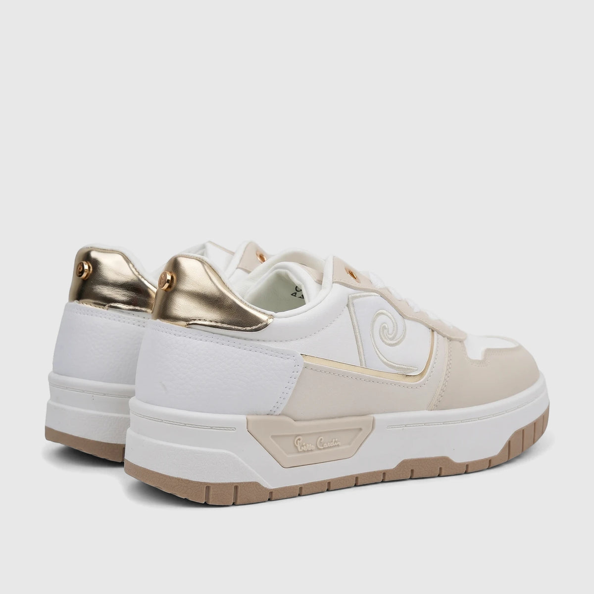 White and beige PC Ladies Casual Sneakers with gold heel accents and a side swirl detail, viewed from the rear-side angle.