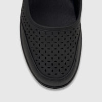 Close-up overhead view of a black PC Ladies Casual Wedge shoe featuring a perforated vamp design and durable sole.