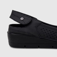 Black PC Ladies Casual Wedge PCL10994 shoe, featuring a perforated design, an adjustable strap, and a textured wedge heel.