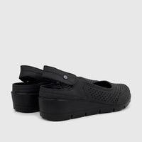Black PC Ladies Casual Wedge sandals featuring perforated uppers, an adjustable ankle strap, and a comfortable wedge heel.