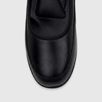 Close-up top view of a black leather PC Ladies Comfort Pump shoe, showcasing its smooth texture and stitching.