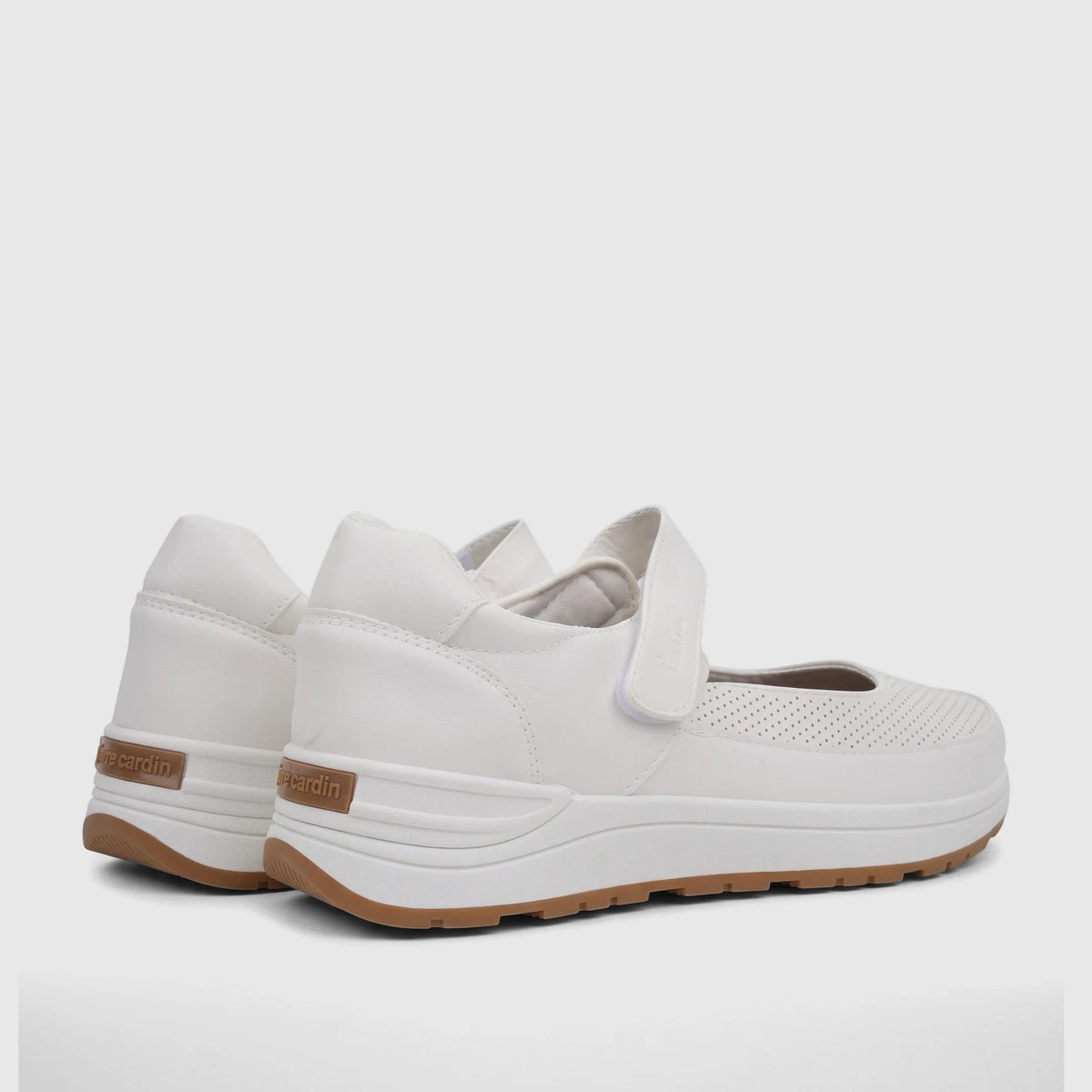 Rear-side view of white PC Ladies Comfort Pump PCL10986 shoes with tan soles and perforated details on a studio background.