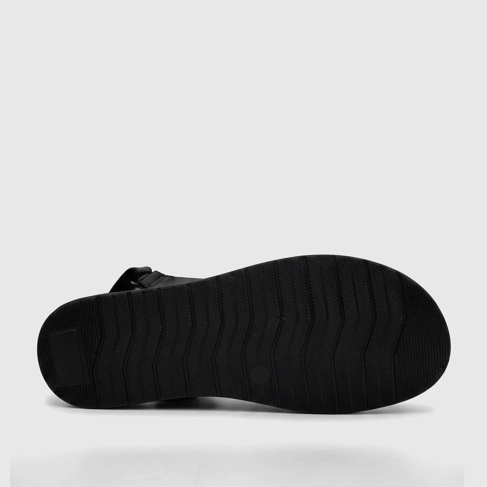 Black ladies comfort sandal, bottom view, showcasing the sole with textured grip pattern for traction.