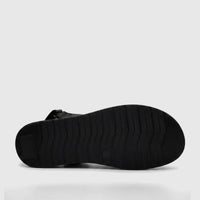 Black ladies comfort sandal, bottom view, showcasing the sole with textured grip pattern for traction.