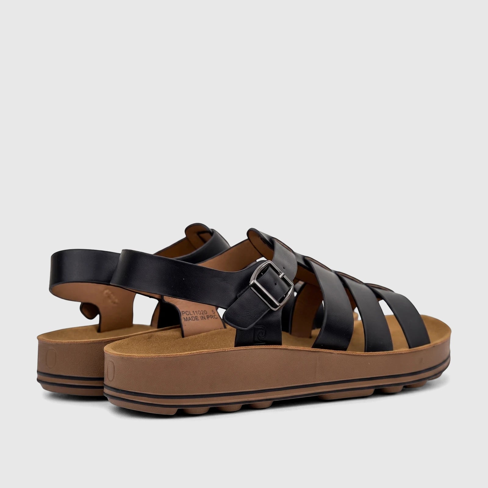 A pair of black PC Ladies Comfort Sandals with strappy uppers and thick brown platform soles, viewed from a side angle.