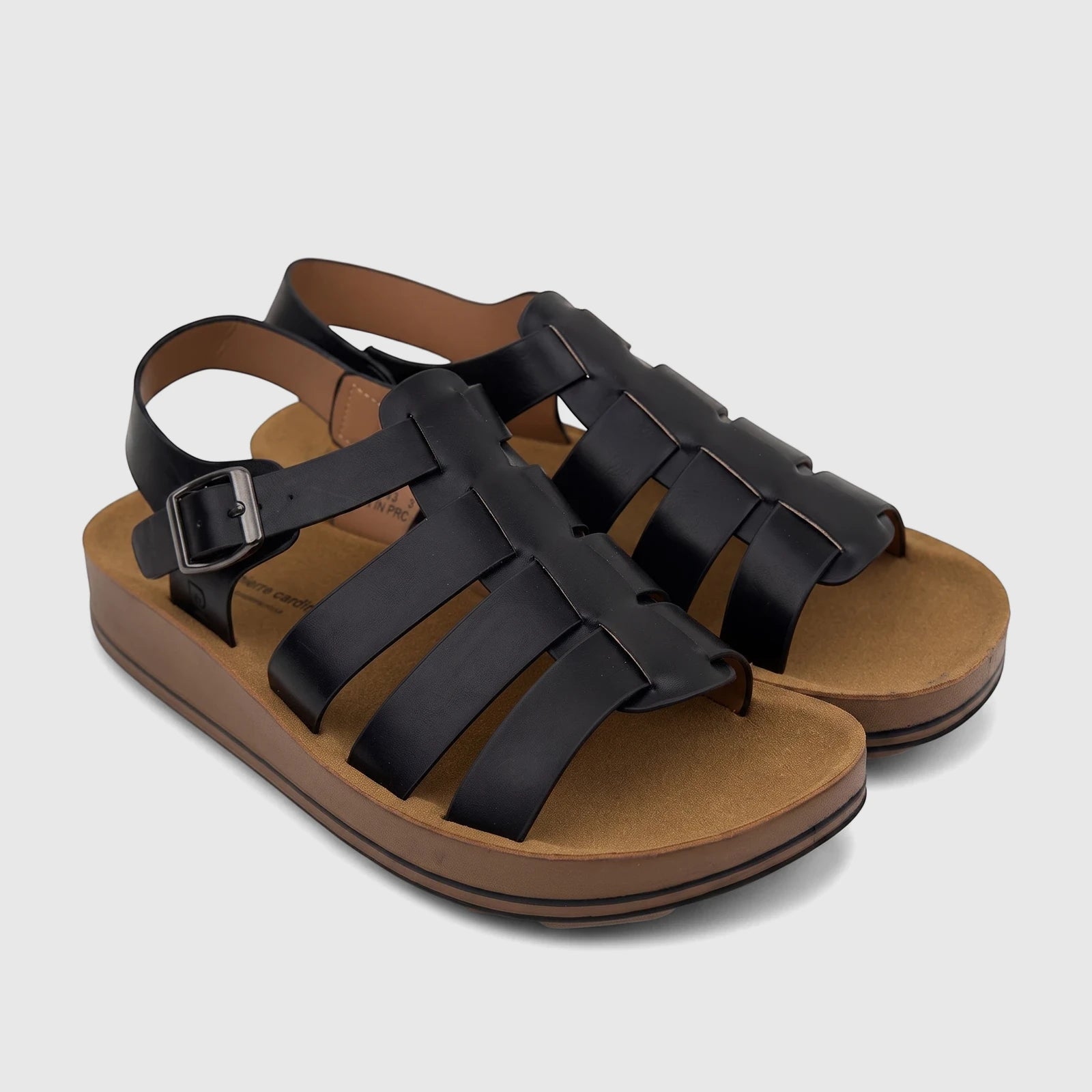 Black ladies' comfort sandals with woven straps, a metallic buckle, and a brown platform sole, shown from an oblique view.
