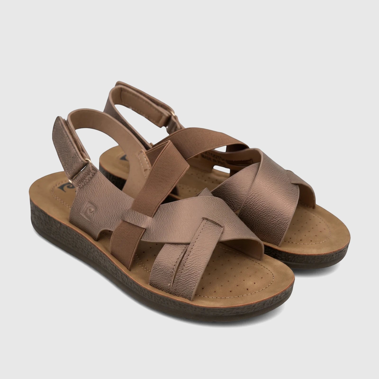Pair of PC Ladies Comfort Sandals in bronze, featuring criss-cross elastic straps and a comfort sole, angled on a surface.