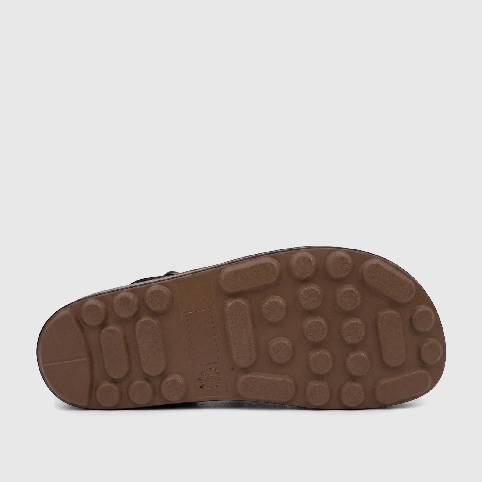A close-up, side view of a PC Ladies Comfort Sandal, featuring its distinctive brown textured sole with circular and oblong