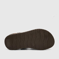 Bottom view of a PC Ladies Comfort Sandal, featuring a dark brown textured sole with a distinct wavy tread pattern.