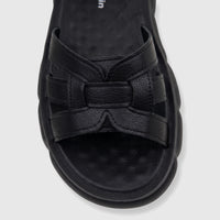 Close-up of a black PC Ladies Comfort Sandal with textured straps and a thick, sculpted sole, viewed from above.