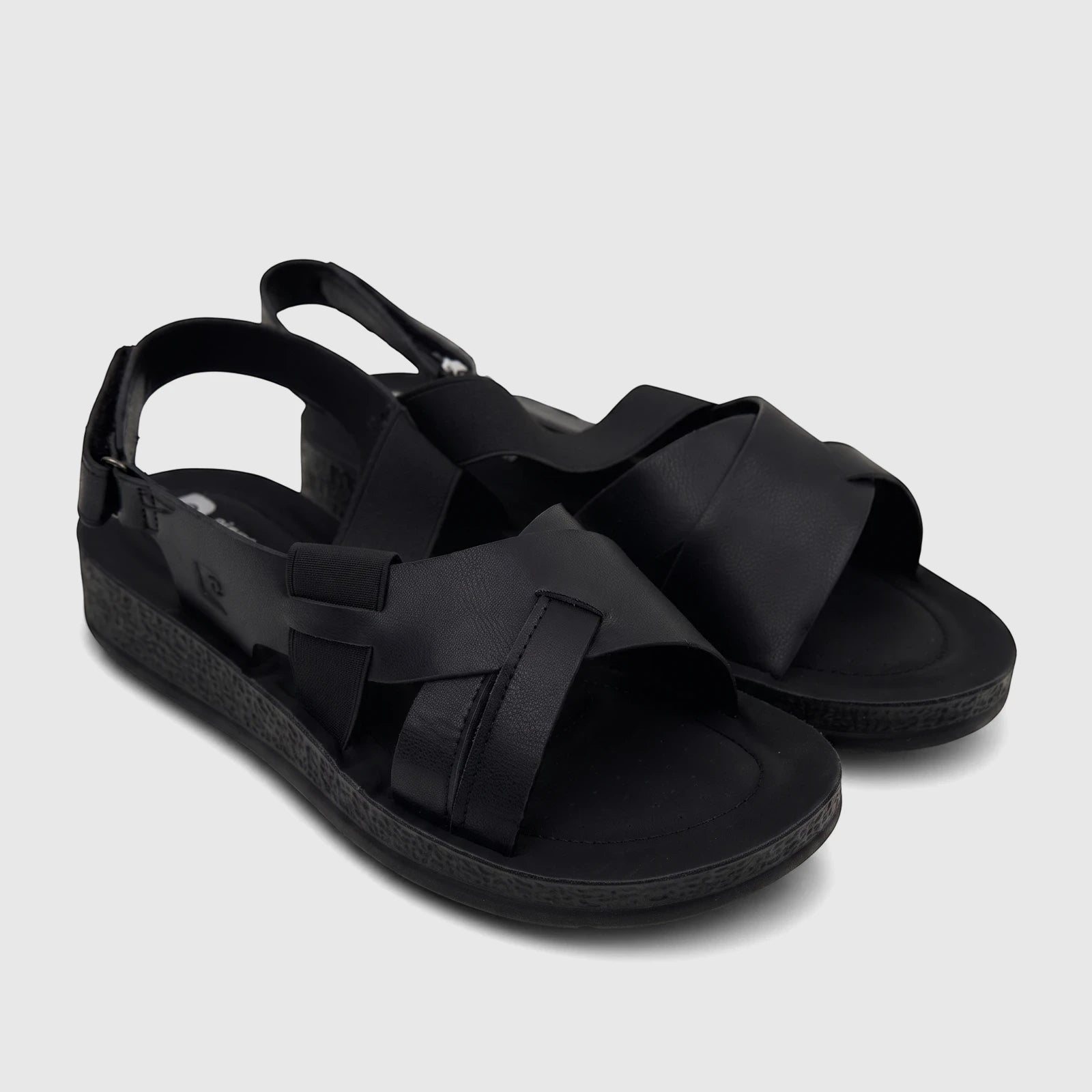 A pair of black PC Ladies Comfort Sandals PCL10975, featuring criss-cross straps and textured soles, presented on a white