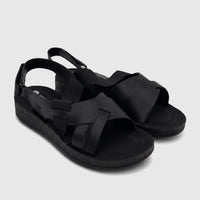A pair of black PC Ladies Comfort Sandals PCL10975, featuring criss-cross straps and textured soles, presented on a white
