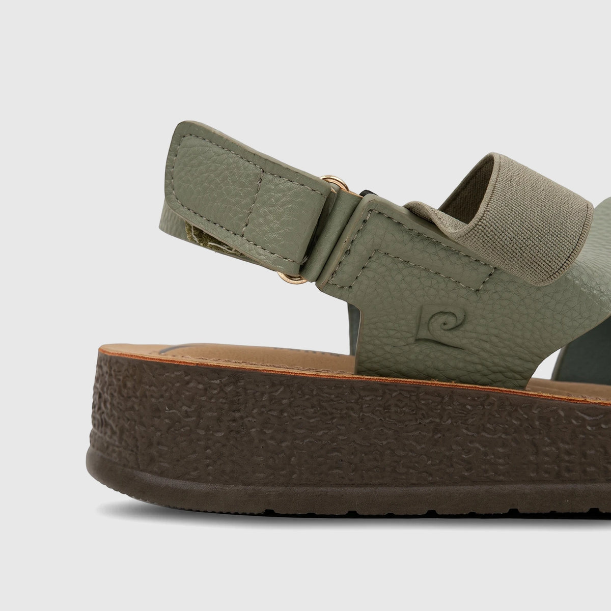 Side view of a sage green PC Ladies Comfort Sandal, featuring textured straps, gold hardware, and a thick brown sole.