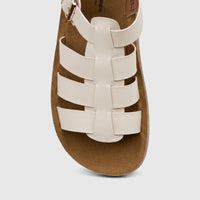 White PC Ladies Comfort Sandal with a strappy design and cork-like sole, featuring a gold buckle, shown from a top-down view.