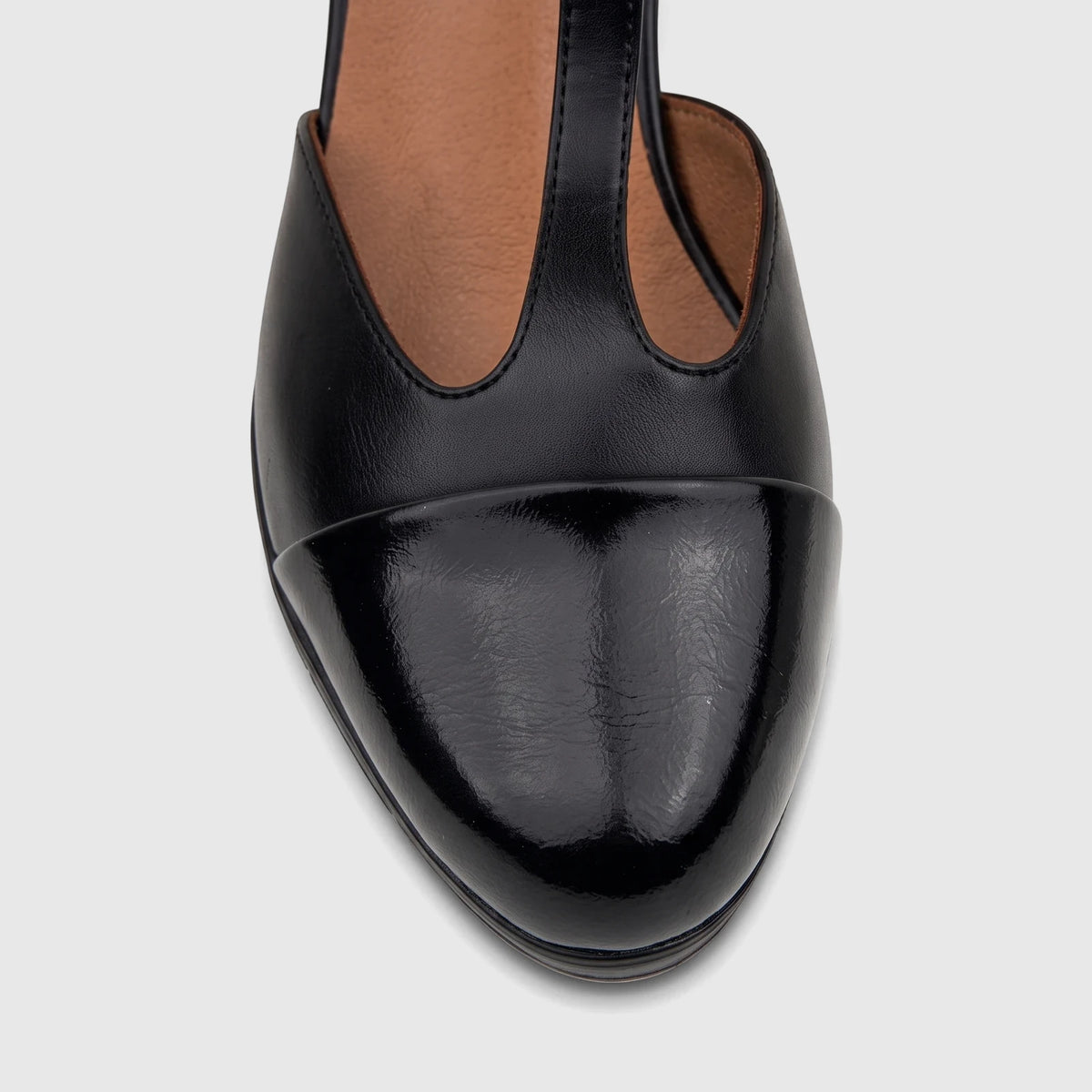 Close-up of a black leather PC Ladies Dress Block Heel T Bar shoe with patent cap toe, offering a sophisticated and