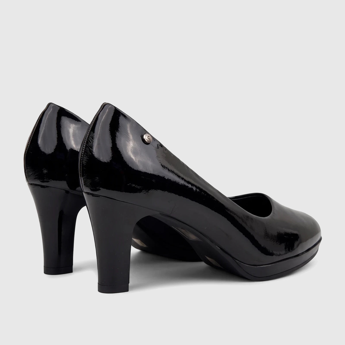 A pair of elegant PC Ladies Dress Court high heels, PCL10708, in a glossy black patent finish, seen from the side.