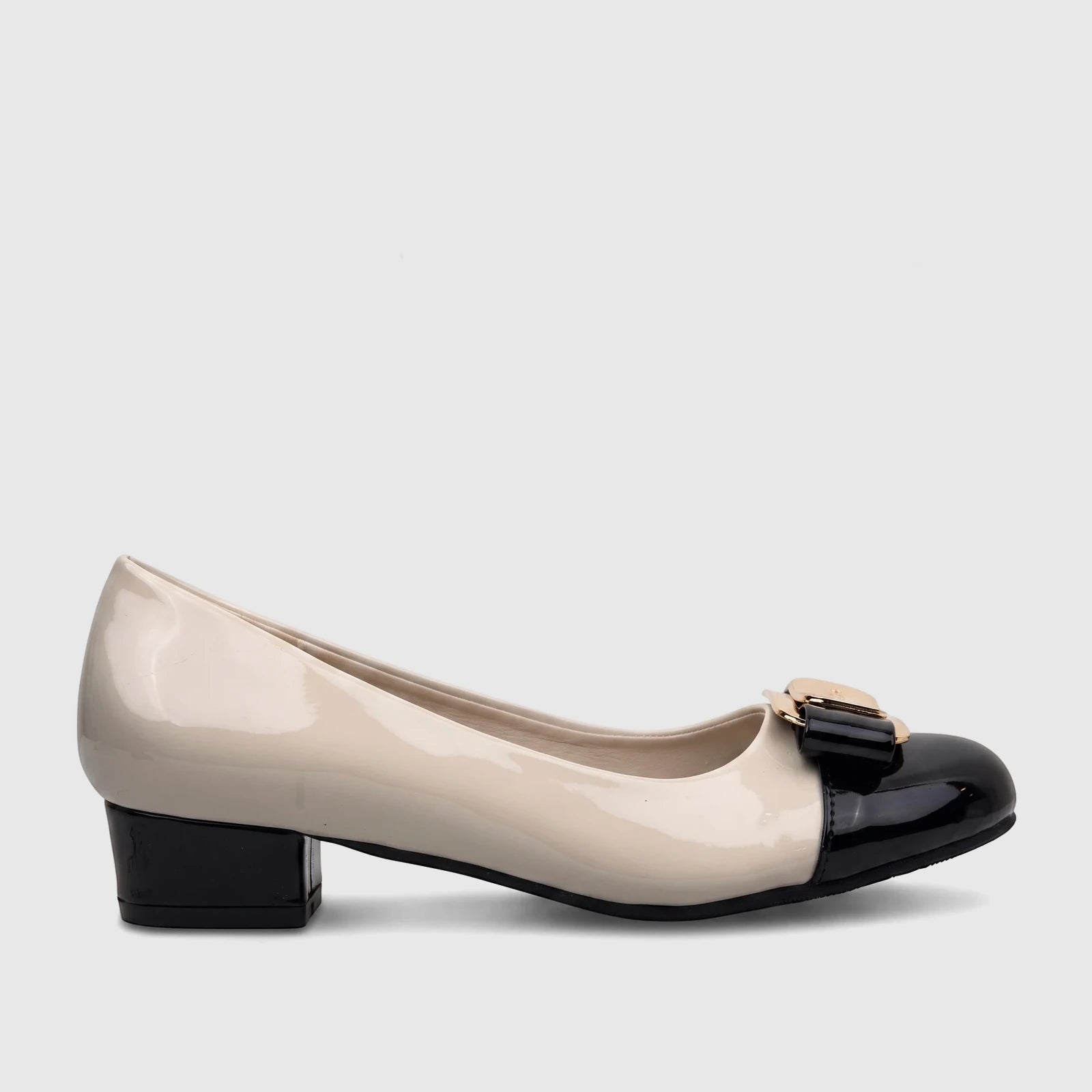 Side view of a women's PC patent leather court shoe in nude and black with a gold-tone buckle accent on the vamp.