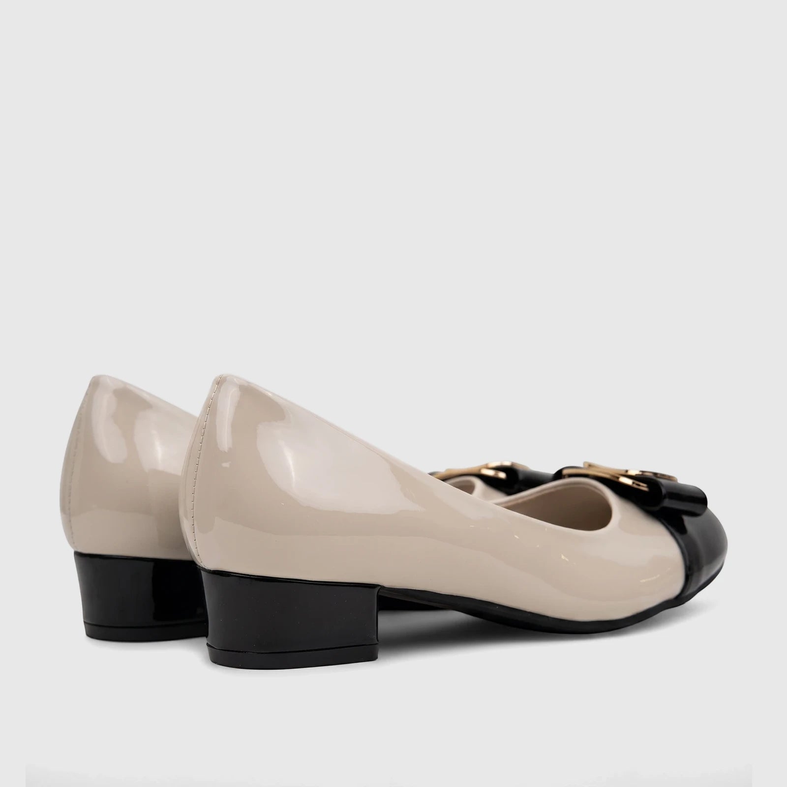 PC Ladies Dress Court Shoe in black and nude patent leather with a low block heel, featuring a decorative bow and gold