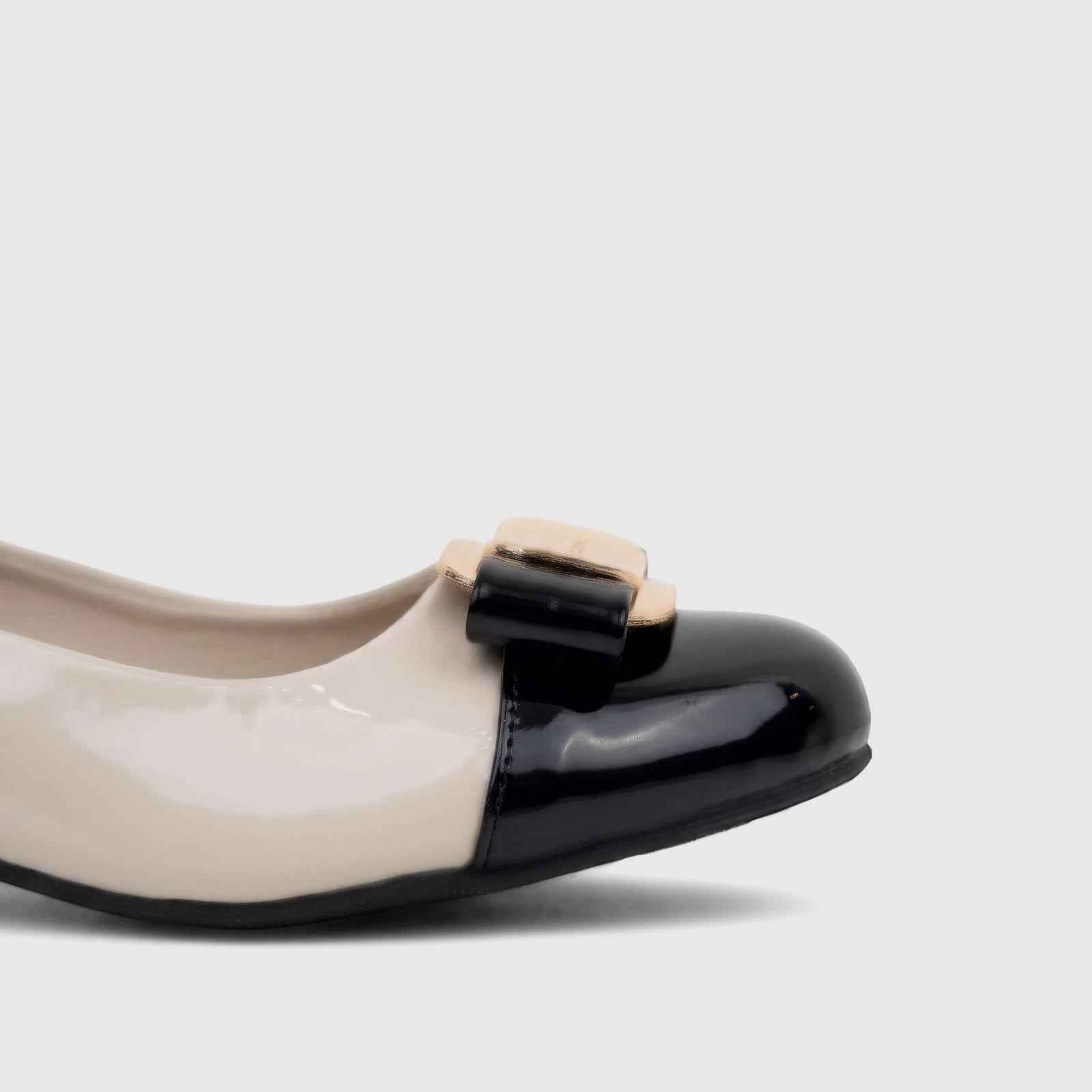 PC Ladies Dress Court Shoe PCL11026 featuring a black and nude patent leather design with a stylish gold buckle and bow