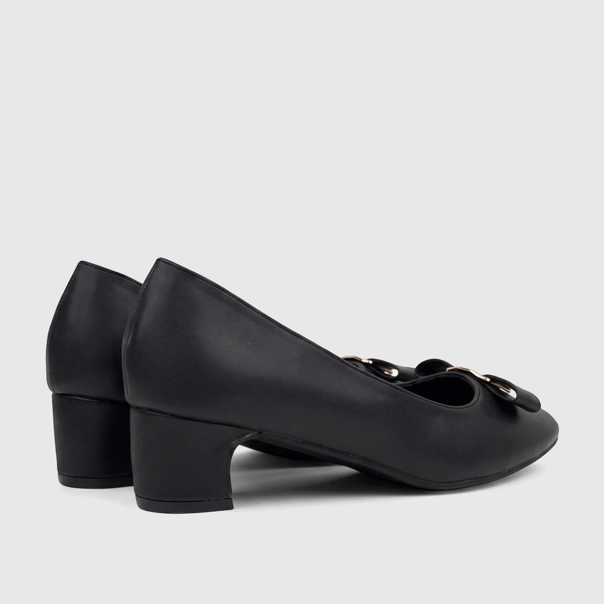 Black ladies dress court shoes with a block heel and gold buckle detailing, viewed from a side angle.