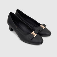 Black PC Ladies Dress Court shoes with block heels, leather upper, and gold buckle-bow detail, seen from an elevated angle.