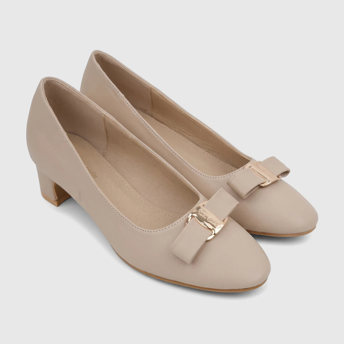 Pair of elegant nude faux leather PC Ladies Dress Court shoes with bow details and distinctive gold-tone buckles, in a