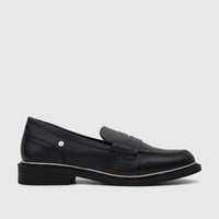 Black leather PC Ladies Dress Loafer, featuring a gold-tone logo and metallic trim detail, shown in a side profile view.