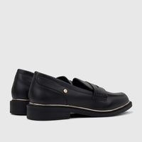 Pair of black PC Ladies Dress Loafers PCL10996, made of leather with a gold-tone trim, captured from a side angle.