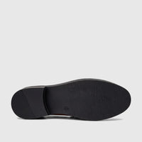 Underside view of a black PC Ladies Dress Loafer shoe, featuring a textured sole and a small heel.