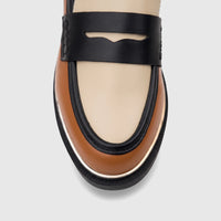 Close-up of a PC Ladies Dress Loafer in tan, cream, and black multi-color, featuring a classic penny strap design.