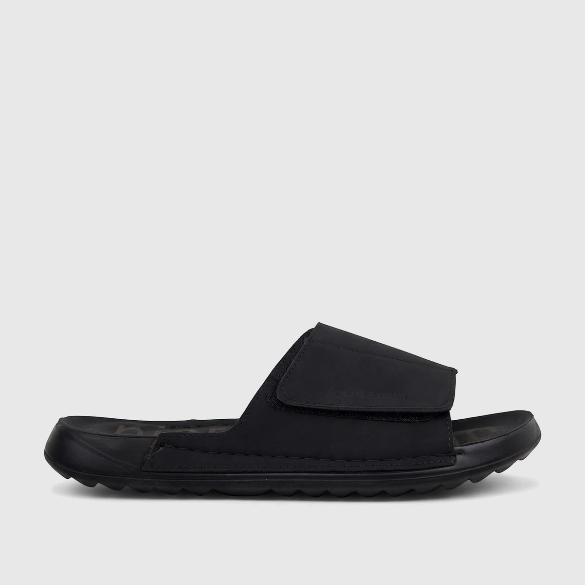 Men's black comfort slide sandal with a textured sole and adjustable strap, shown in a side profile view.