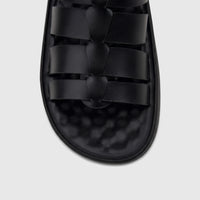 Close-up view of a PC Men's Casual Comfort Sandal in black, featuring multiple braided straps across the top.
