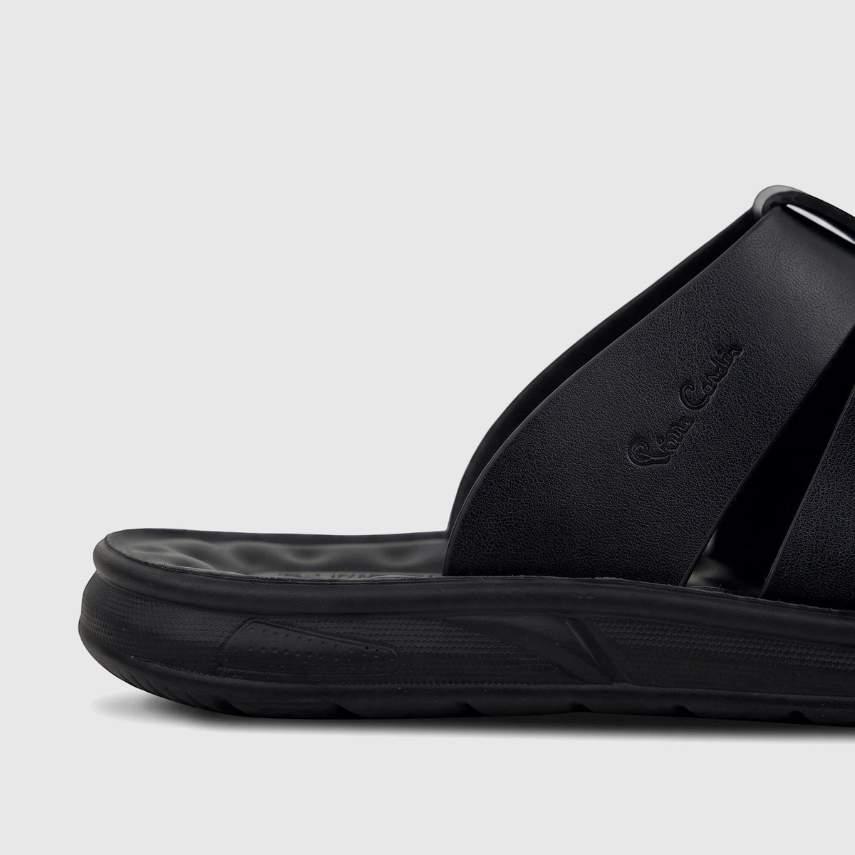 Close-up of a black PC Men's Casual/Comfort Sandal, showing the textured strap with the embossed logo and the sturdy sole.